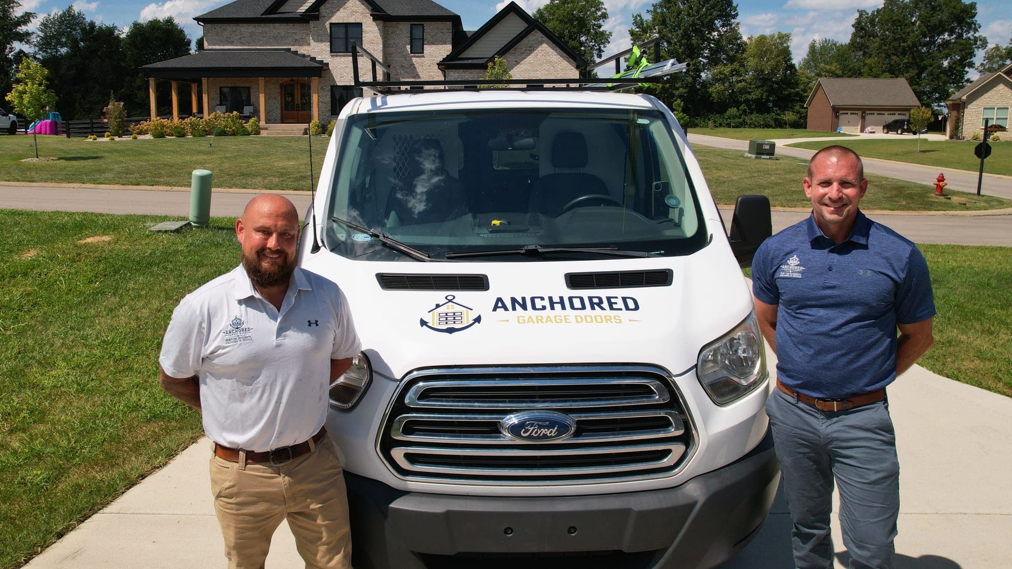Tyler White and Jacob Schneider with the Anchored Garage Doors van