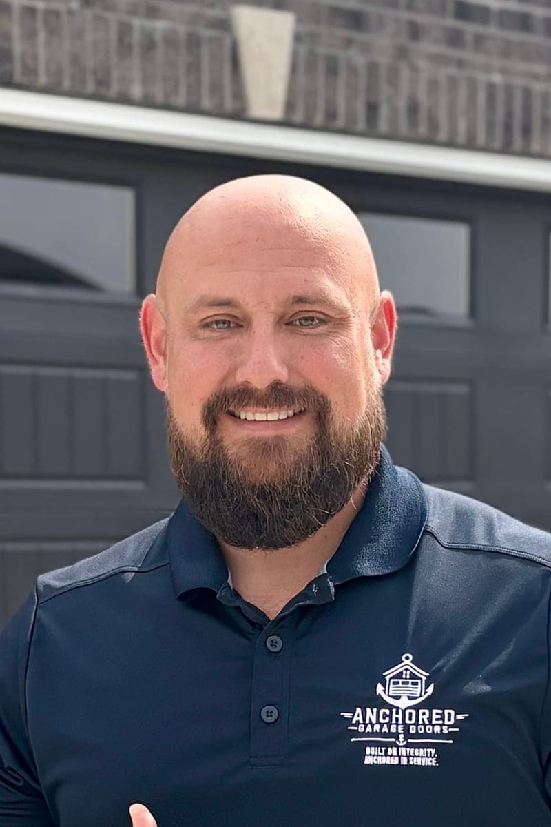 Tyler White in an Anchored polo shirt, outside a finished garage door